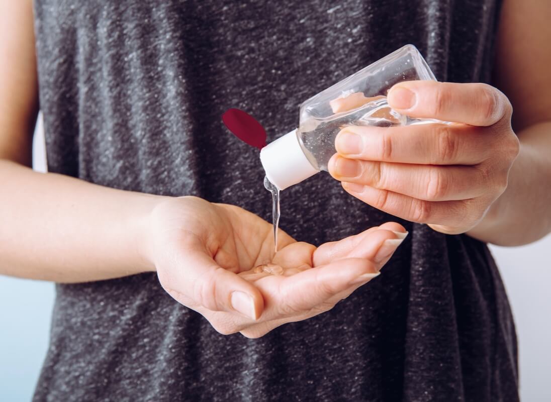 Person pouring sanitizing gel into their own hands